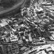 Aerial view showing Canongate running down centre of photograph, Regent Road at bottom, Meadow Flat Gas Holder to left, Viewcraig at top, and Moray House College to right