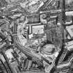 Oblique aerial view of Edinburgh centred on the construction of Exchange Crescent, taken from the W.