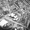 Oblique aerial view centred on the offices with the school, burial ground and church adjacent, taken from the E.