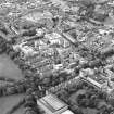 Oblique aerial view centred on the hospital with the school adjacent, taken from the SE.