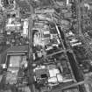 Oblique aerial view centred on the brewery with the canal, canal basin and canal bridge adjacent, taken from the WSW.
