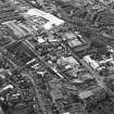 Oblique aerial view centred on the brewery with the leisure centre and cinema, canal, canal basin and canal bridge adjacent, taken from the E.
