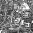Oblique aerial view centred on the brewery with the leisure centre and cinema, canal, canal basin and canal bridge adjacent, taken from the NE.