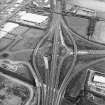 Oblique aerial view centred on the motorway interchange, taken from the NNW.