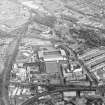 General oblique aerial view centred on the football ground and stadium with the whisky distillery adjacent, taken from the W.