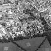 Oblique aerial view centred on the hospital with the chapel, hospital and school adjacent, taken from the S.