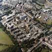 Oblique aerial view centred on the hospital with the chapel, hospital and school adjacent, taken from the ESE.