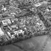 Oblique aerial view centred on the hospital with the chapel, hospital and school adjacent, taken from the S.