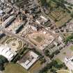 Oblique aerial view centred on the Scottish Parliament under construction with 'Our Dynamic Earth' adjacent, taken from the ESE.