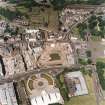 Oblique aerial view centred on the Scottish Parliament under construction with 'Our Dynamic Earth' adjacent, taken from the SSE.