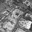 Oblique aerial view centred on the Scottish Parliament under construction with 'Our Dynamic Earth' and Holyrood Palace adjacent, taken from the SW.