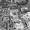 Oblique aerial view centred on the Scottish Parliament under construction with 'Our Dynamic Earth' and Holyrood Palace adjacent, taken from the WSW.