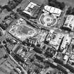 Oblique aerial view centred on the Scottish Parliament under construction with 'Our Dynamic Earth' adjacent, taken from the NW.