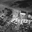 Oblique aerial view centred on the Scottish Parliament under construction with `Our Dynamic Earth¿ and the palace adjacent, taken from the NW.
