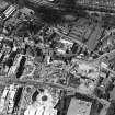 Oblique aerial view centred on the construction site, with exhibition centre and Queensbury House adjacent, taken from the S.