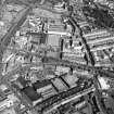 Oblique aerial view centred on the bonded warehouse with the football stadium adjacent, taken from the W.