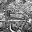 Oblique aerial view centred on the bonded warehouse with the park and bowling green adjacent, taken from the SW.