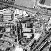 Oblique aerial view centred on the bonded warehouse with the park and bowling green adjacent, taken from the SE.