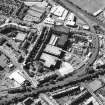 Oblique aerial view centred on the bonded warehouse with the park and bowling green adjacent, taken from the ESE.