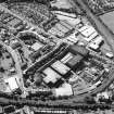 Oblique aerial view centred on the bonded warehouse with the park and bowling green adjacent, taken from the E.