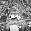 Oblique aerial view centred on the offices with the school, burial ground and church adjacent, taken from the SE.