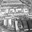 Oblique aerial view centred on Sinclair Place with bakery, factory and brewery adjacent, taken from the WSW.