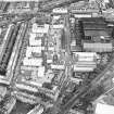 Oblique aerial view centred on Sinclair Place with bakery, factory and brewery adjacent, taken from the NW.