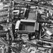 Oblique aerial view of Edinburgh centred on Tynecastle Park Stadium and the North British Distillery, taken from the ENE.