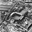 Oblique aerial view of Edinburgh centred on Tynecastle Park Stadium and the North British Distillery, taken from the NE.