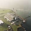 Oblique aerial view of the Cockenzie Generating Station centred on the power station with a harbour adjacent, taken from the E.