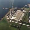 Oblique aerial view of the Cockenzie Generating Station centred on the powerstation with a harbour adjacent, taken from the S.