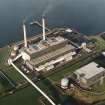 Oblique aerial view of the Cockenzie Generating Station centred on the power station with a harbour adjacent, taken from the SE.