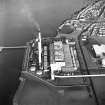 Oblique aerial view of the Cockenzie Generating Station centred on the power station with harbours adjacent, taken from the SE.