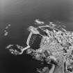 Oblique aerial view centred on the harbour with the remains of the battery adjacent, taken from the W.