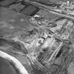 Oblique aerial view centred on the cement works and quarry with the trial excavations adjacent, taken from the NNW.