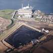 Oblique aerial view centred on the power station and coal store, taken from the SE.