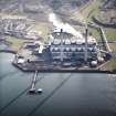 Oblique aerial view centred on the power station and coal store, taken from the NW.