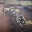 General oblique aerial view centred on the village with the building and farmsteading adjacent, taken from the WNW.