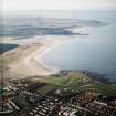 General oblique aerial view looking across the school, club house and Belhaven Bay towards North Berwick Law, the Firth of Forth and the Bass Rock, taken from the ESE.