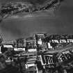 Oblique aerial view of Carrington Parish Church centred on a church witha general view of the burgh, taken from the S.