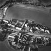 Oblique aerial view of Carrington Parish Church centred on a church with a general view of the burgh, taken from the SE.