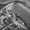 Oblique aerial view of Carrington Parish Church centred on a church with a general view of the burgh, taken from the E.