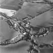 Oblique aerial view of Carrington, General centred on the burgh with an adjacdent church, taken from the W.