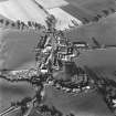 Oblique aerial view of Carrington, General centred on the burgh with an adjacent church, taken from the SW.