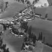 Oblique aerial view of Carrington, General centred on the burgh  with an adjacent church, taken from the SW.