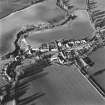 Oblique aerial view of Carrington, General centred on the burgh, with an adjacent church, taken from the S.