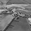 Oblique aerial view of Carrington, General centred on the burgh with an adjacent church, taken from the SW.