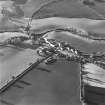 Oblique aerial view of Carrington, General centred on the burgh with an adjacent church, taken from the W.