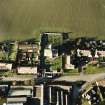 Oblique aerial view of the Carrington Parish Church centred on the church with a general view of the burgh, village, taken from the SE.