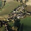 Oblique aerial view of Carrington, General centred on the burgh:village with an adjacent church, taken from the SW.